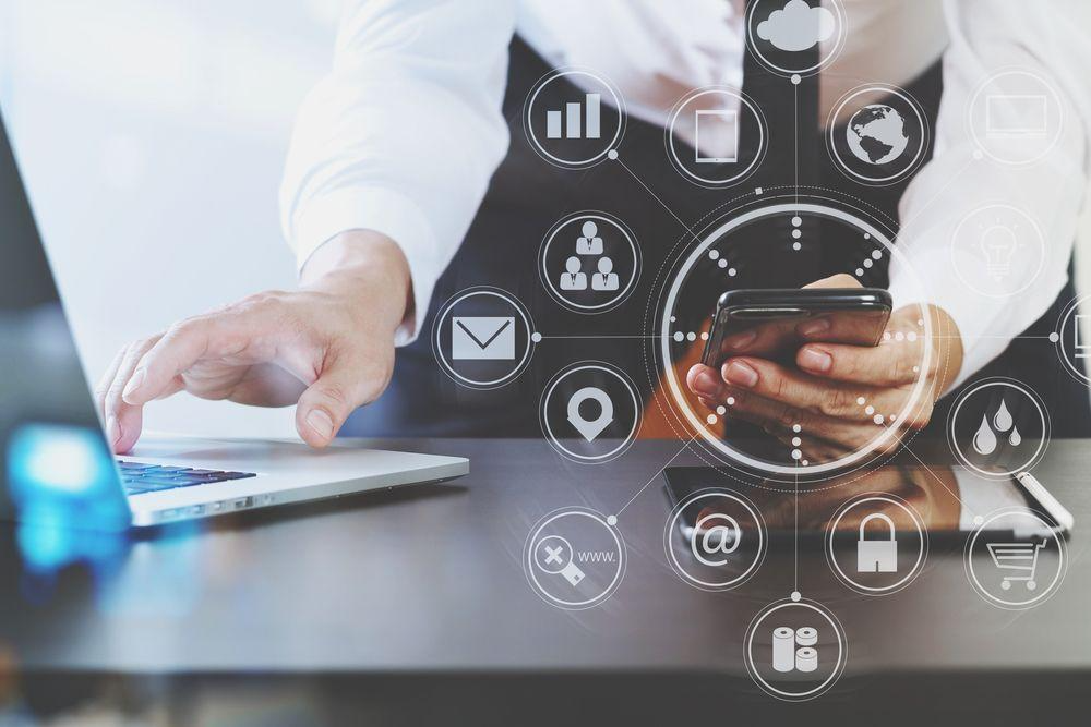 A person using a computer and a phone

Description automatically generated with low confidence